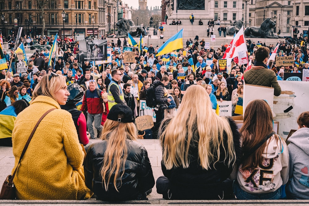 a group of people sitting on the side of a street