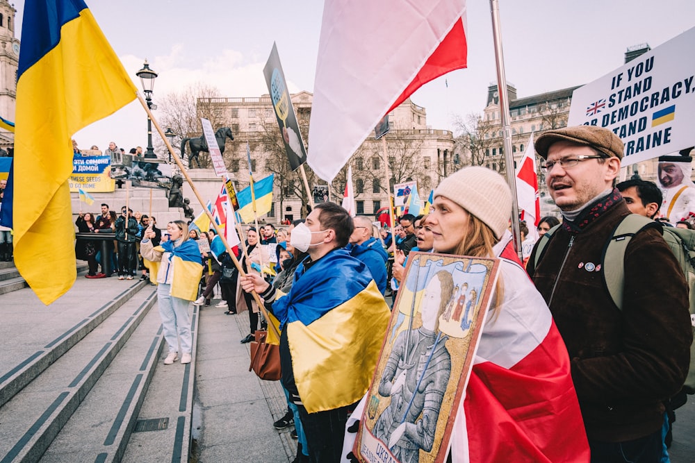 a group of people holding flags and banners