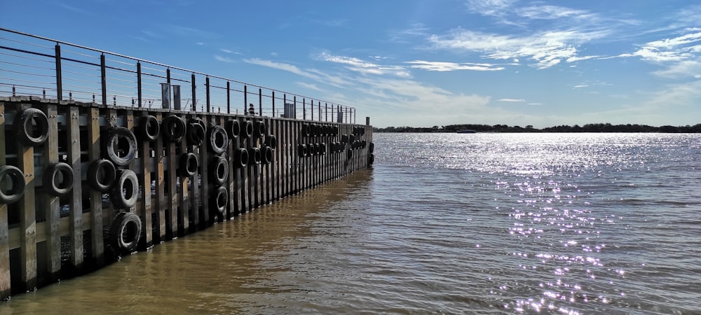 a large body of water next to a metal fence