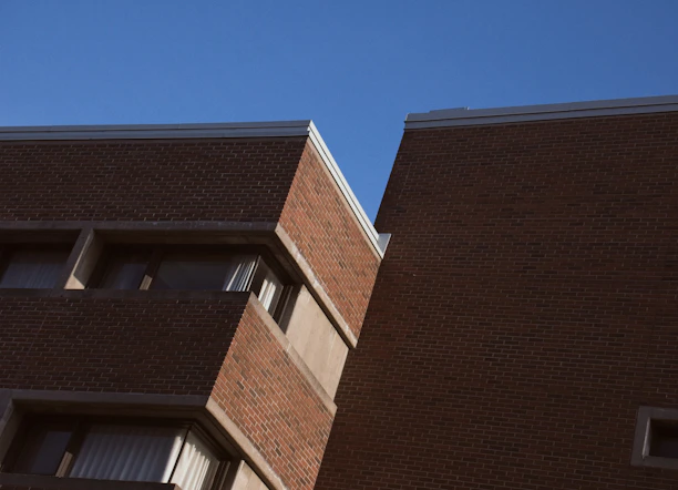 Modern school building with clean architectural lines under a clear blue sky.