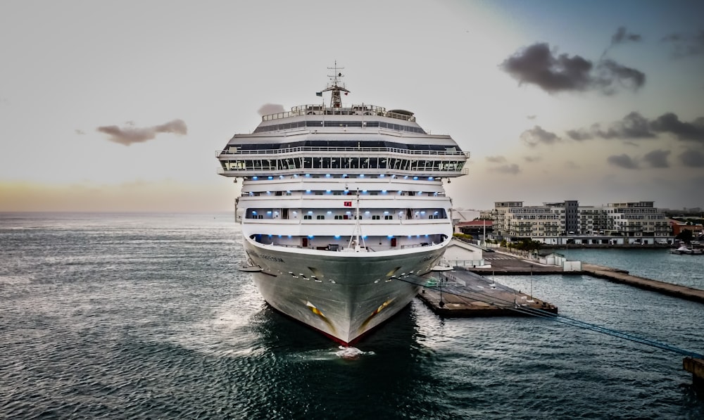 a cruise ship in the water near a dock