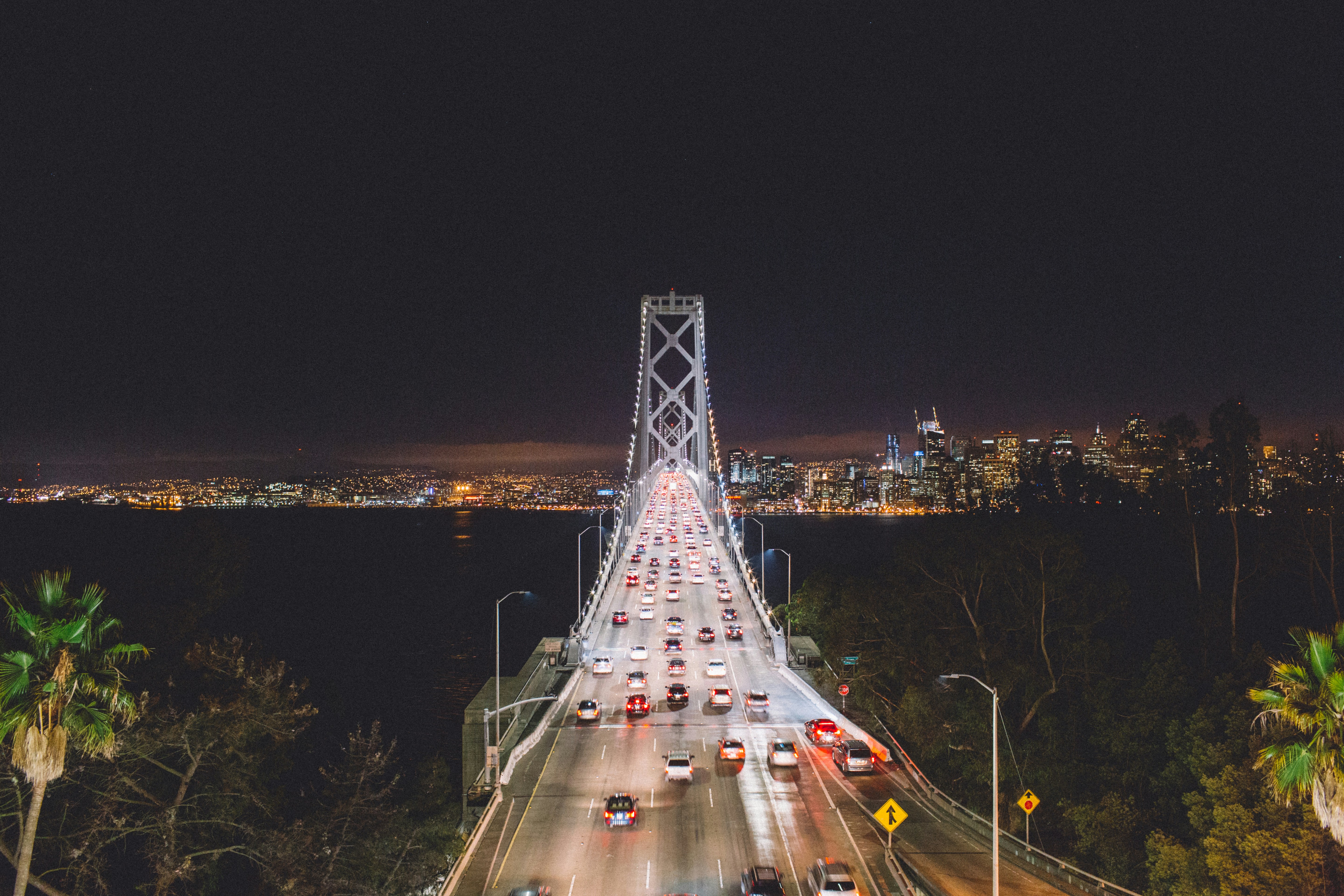 a view of a city at night from the top of a bridge