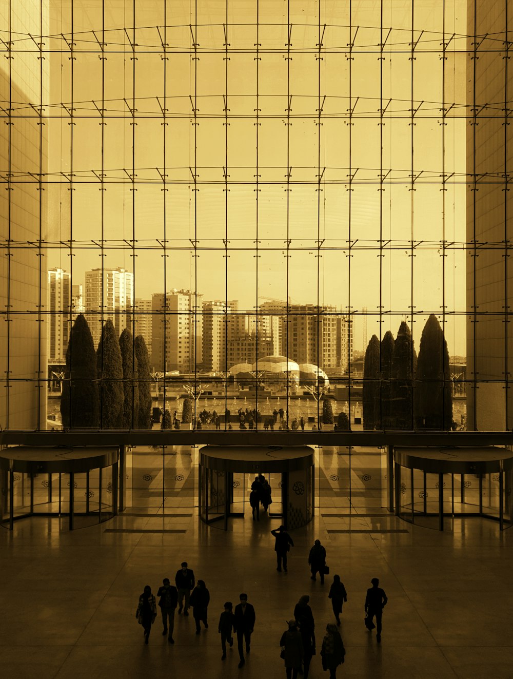 a group of people standing in front of a large window