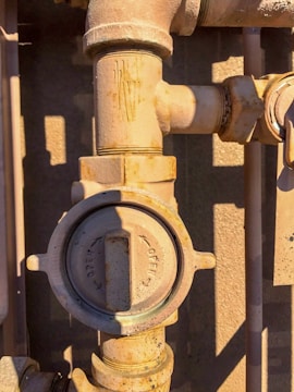 Close-up of a leaking radiator valve being repaired.