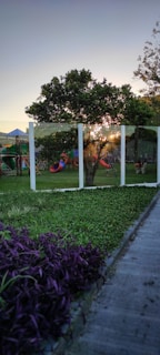 A serene park scene with children playing on swings.