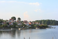 a row of houses sitting on top of a lush green hillside