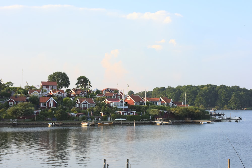 a row of houses sitting on top of a lush green hillside