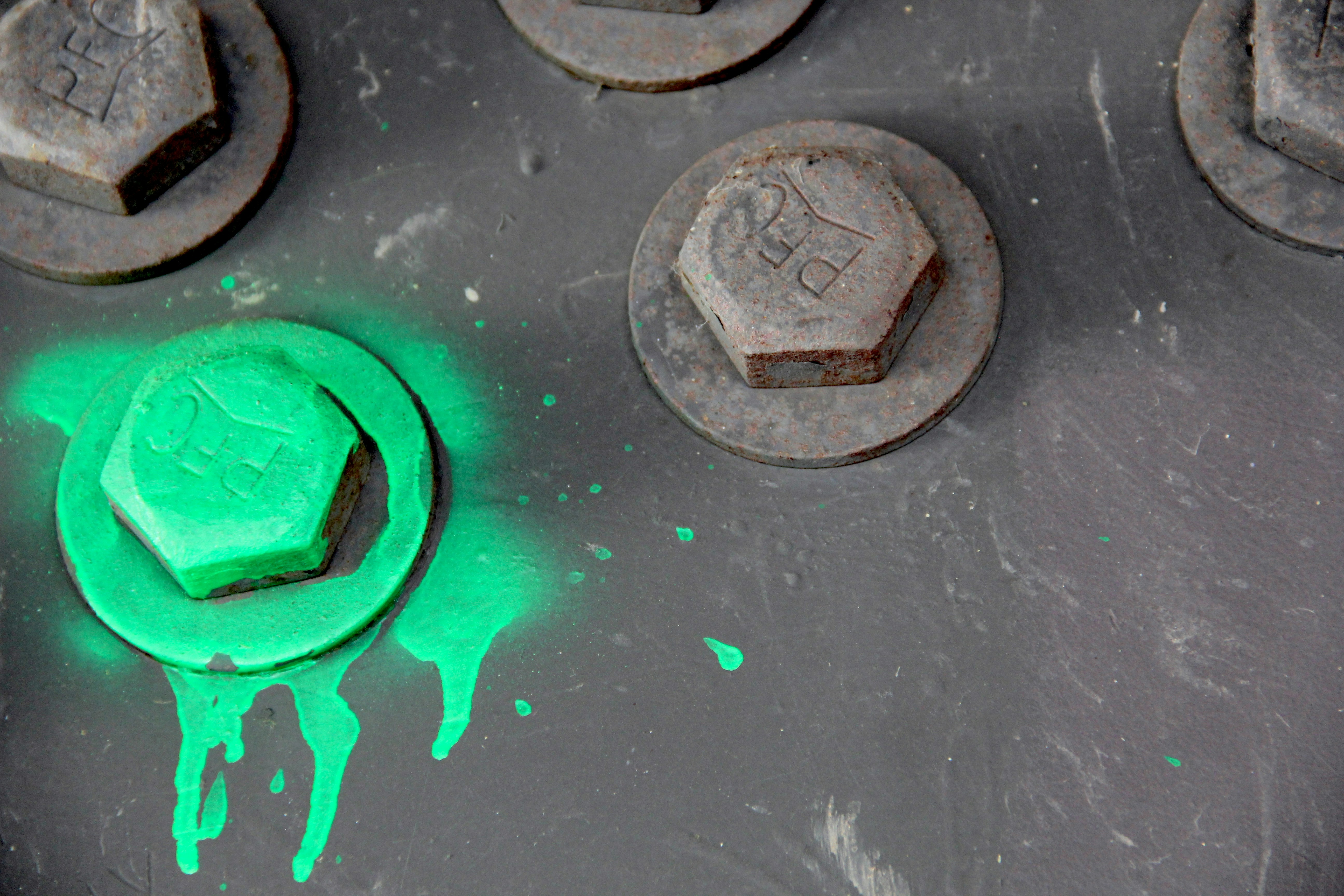 a close up of a green substance on a metal surface