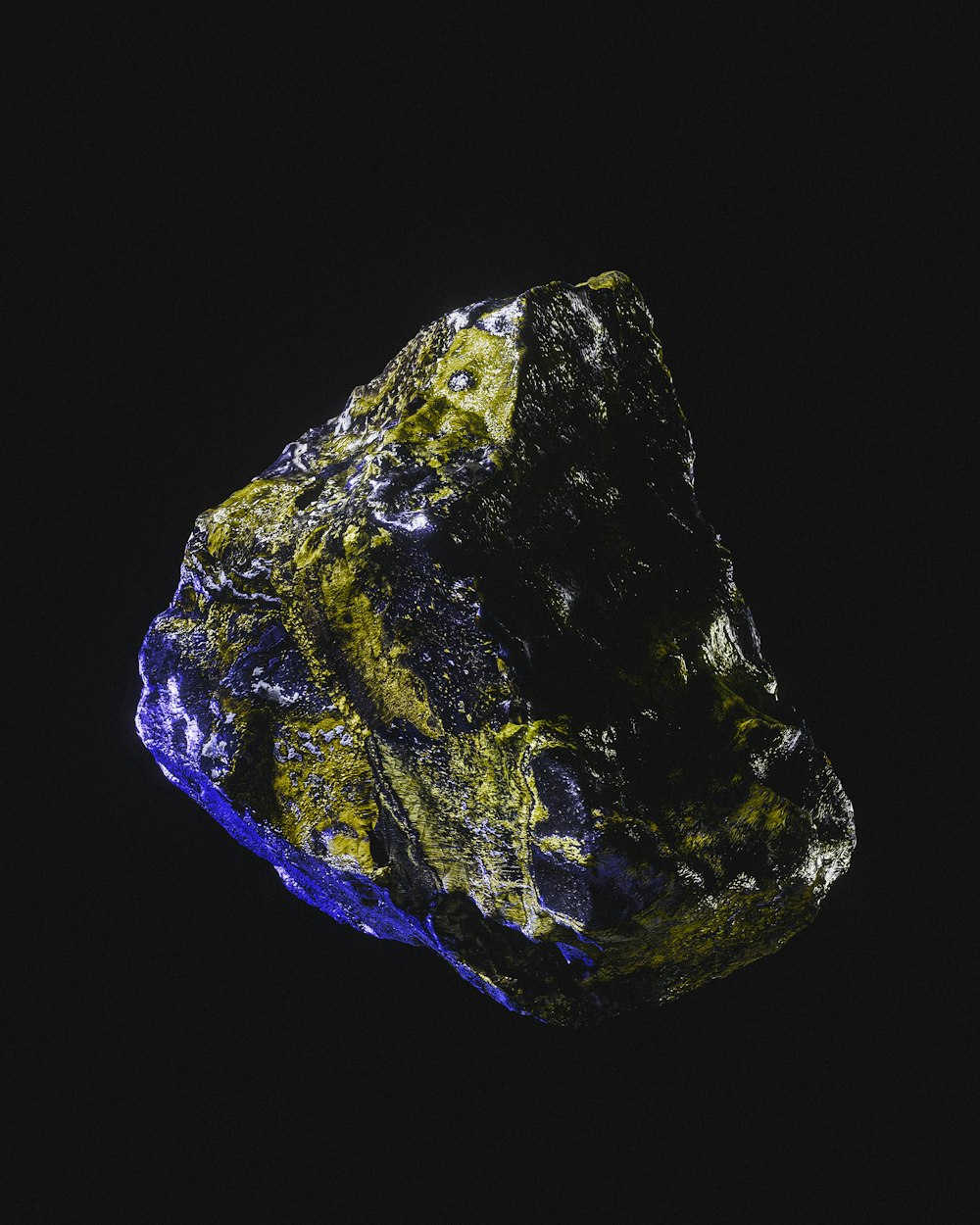 a blue and yellow rock on a black background