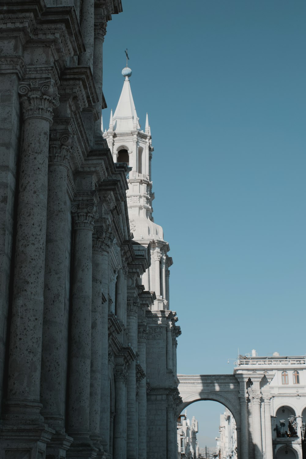 a tall white building with a clock on it's side