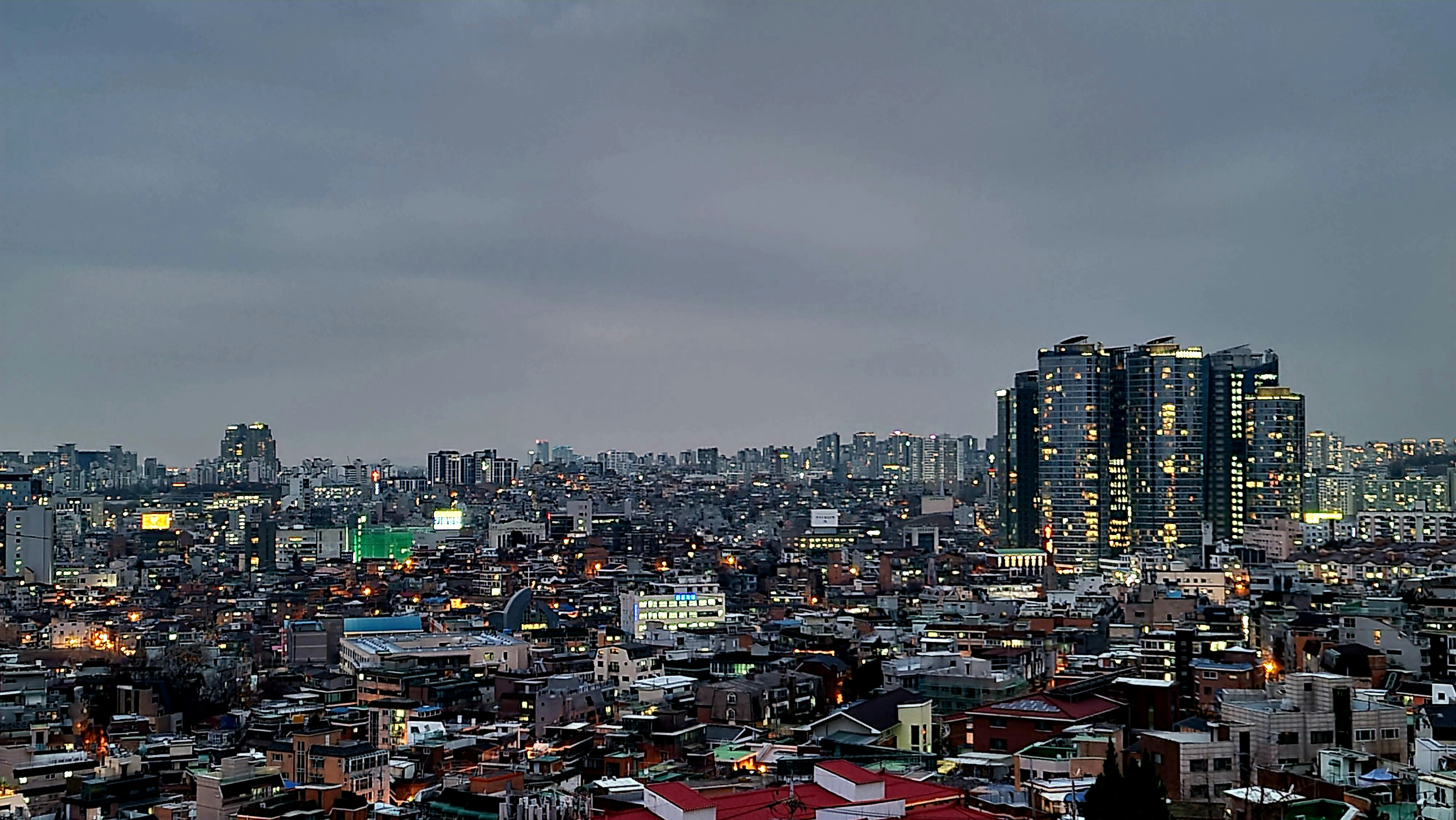 a view of a city at night from the top of a hill