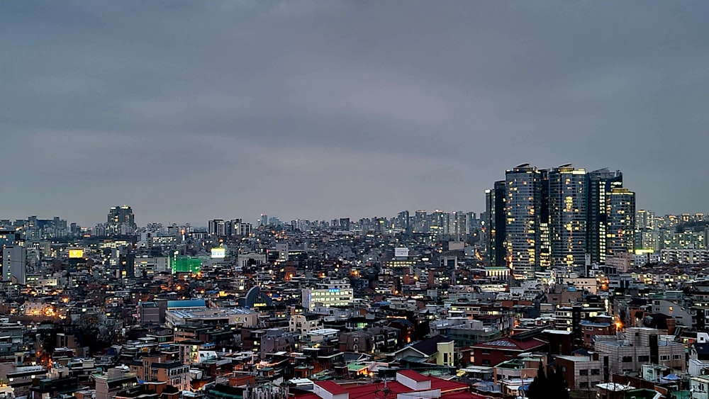 a view of a city at night from the top of a hill