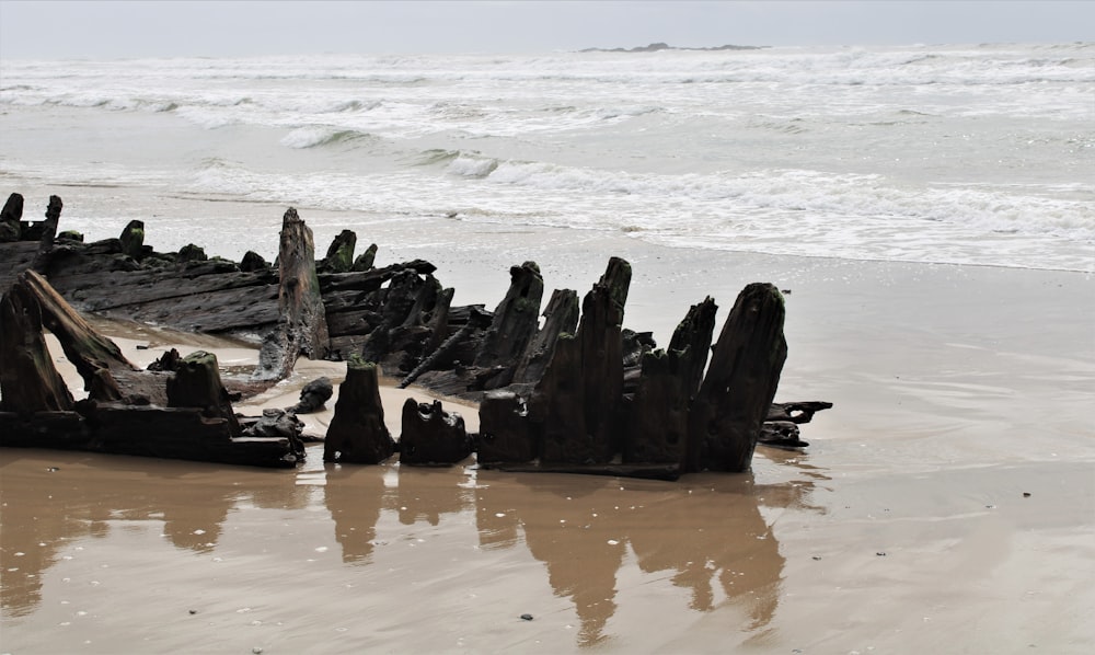 a wooden structure sitting on top of a sandy beach