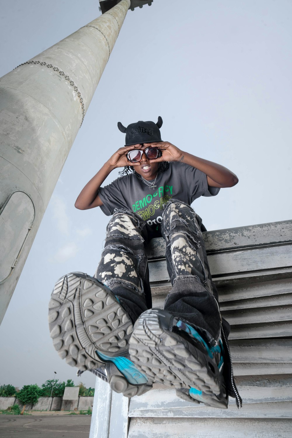 a man sitting on top of a cement structure