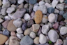 a heart shaped rock sitting on top of a pile of rocks
