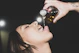 a woman is drinking from a bottle of wine