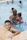 Smiling parents and children enjoying a poolside moment at a family resort