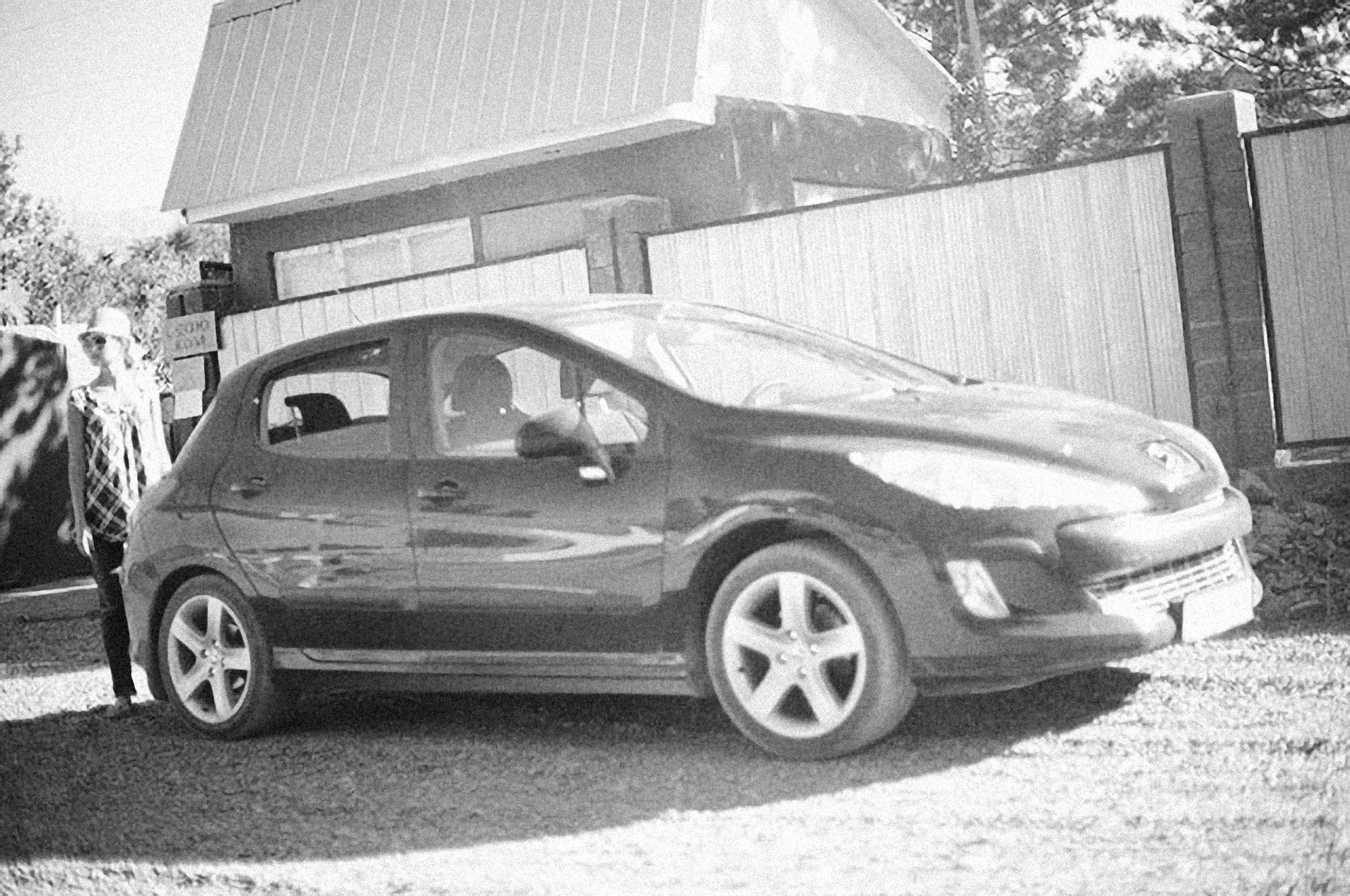a black and white photo of a small car
