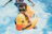 A happy toddler floating safely in a colorful inflatable pool ring on a sunny day.