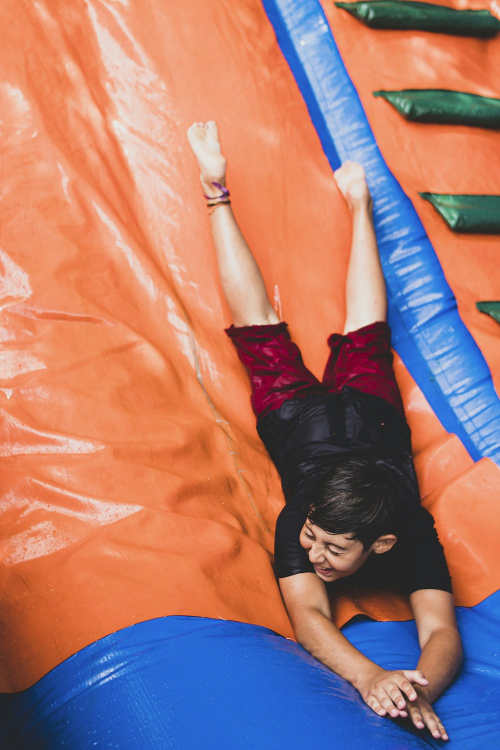 a woman laying on top of an inflatable slide