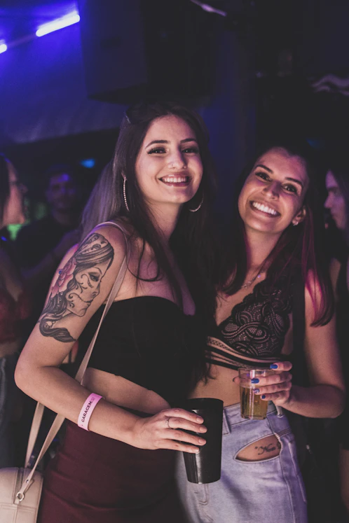 two women standing next to each other at a party