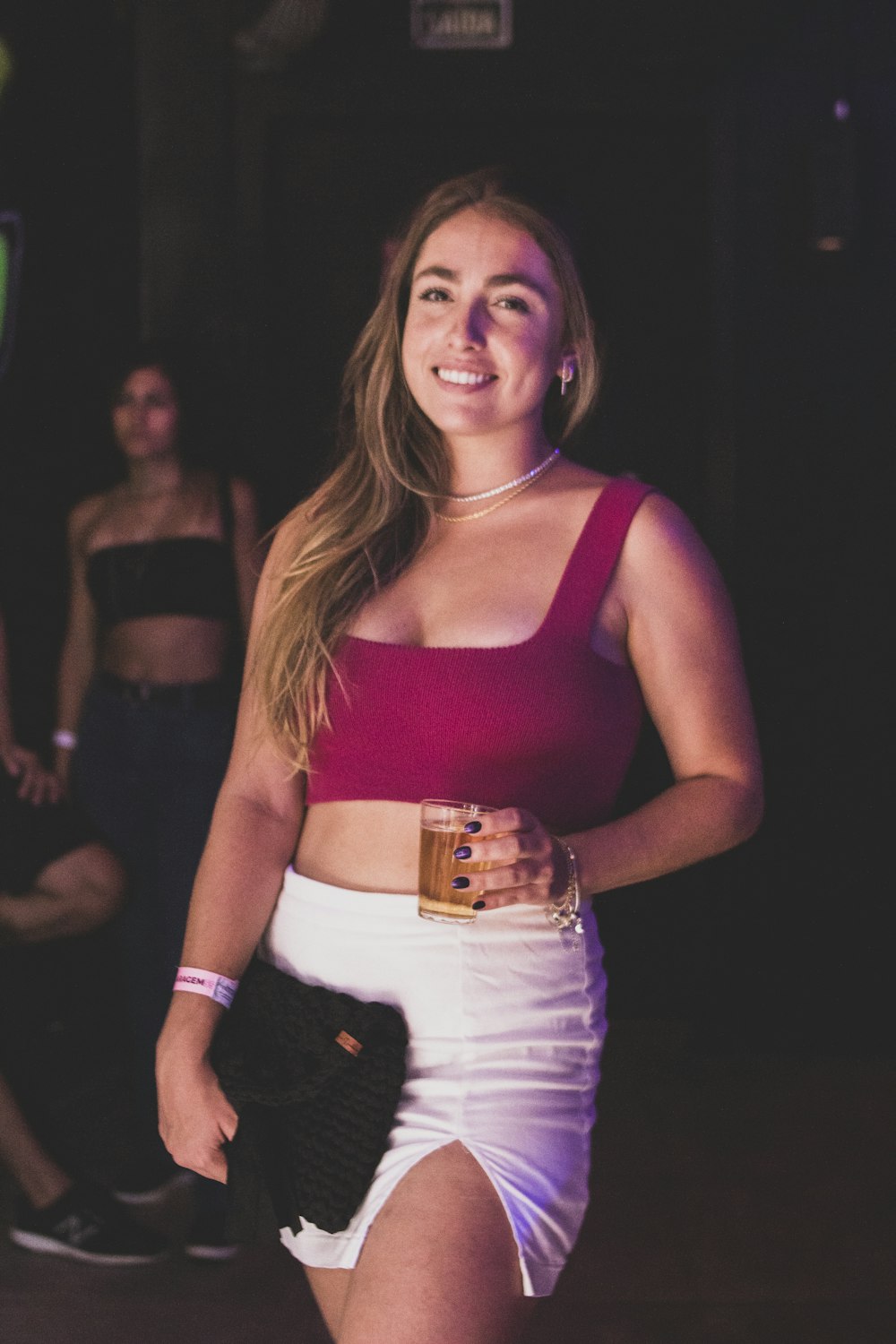 a woman in a red top and white skirt