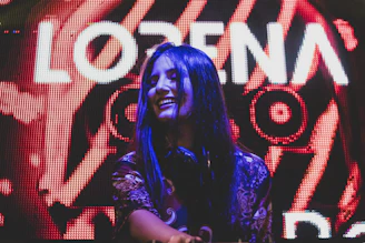 Bright, colorful photo of a pop singer smiling during a lively interview.