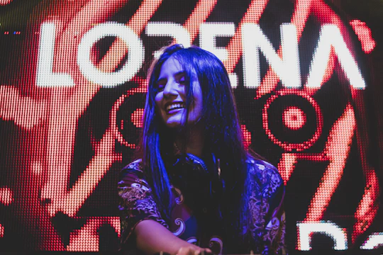 Bright, colorful photo of a pop singer smiling during a lively interview.