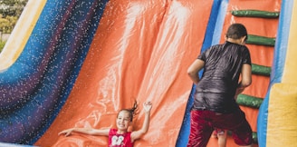 a little girl is playing in a bouncy castle