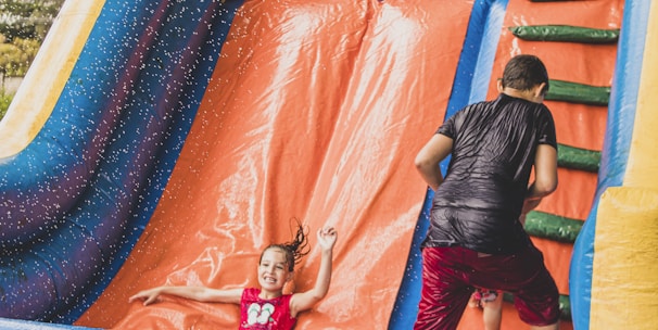 a little girl is playing in a bouncy castle