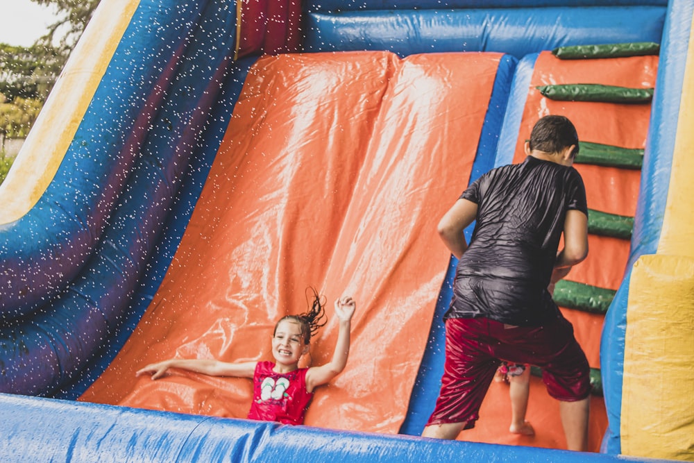 a little girl is playing in a bouncy castle