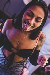 a woman with her mouth open holding a wine glass