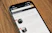 a cell phone sitting on top of a wooden table