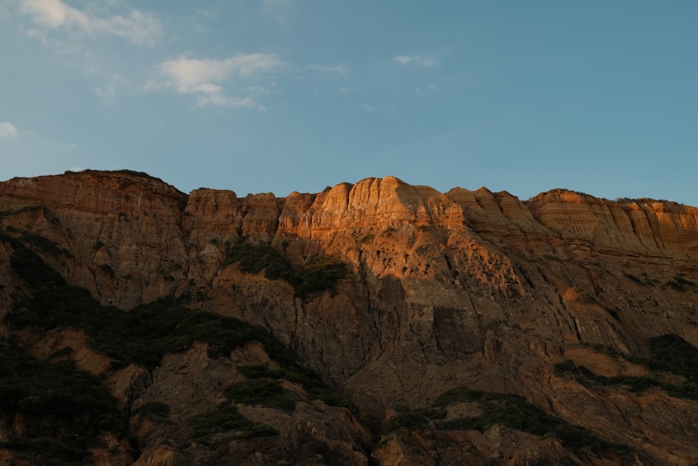 a very tall mountain with a sky in the background