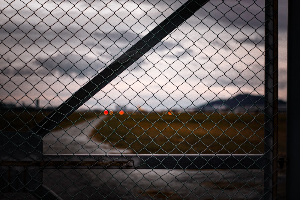 a view of a runway through a chain link fence