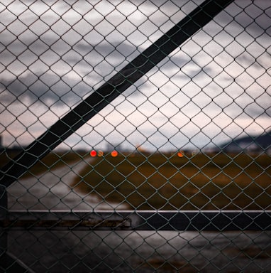a view of a runway through a chain link fence