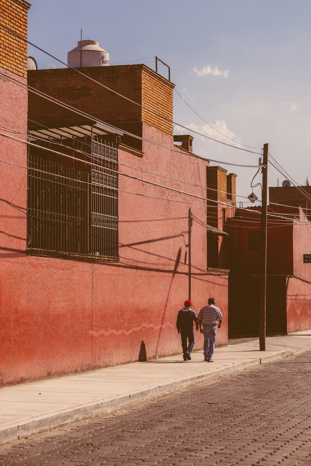 a couple of people walking down a street