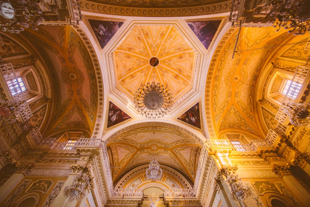 the ceiling of a church with a chandelier hanging from the ceiling