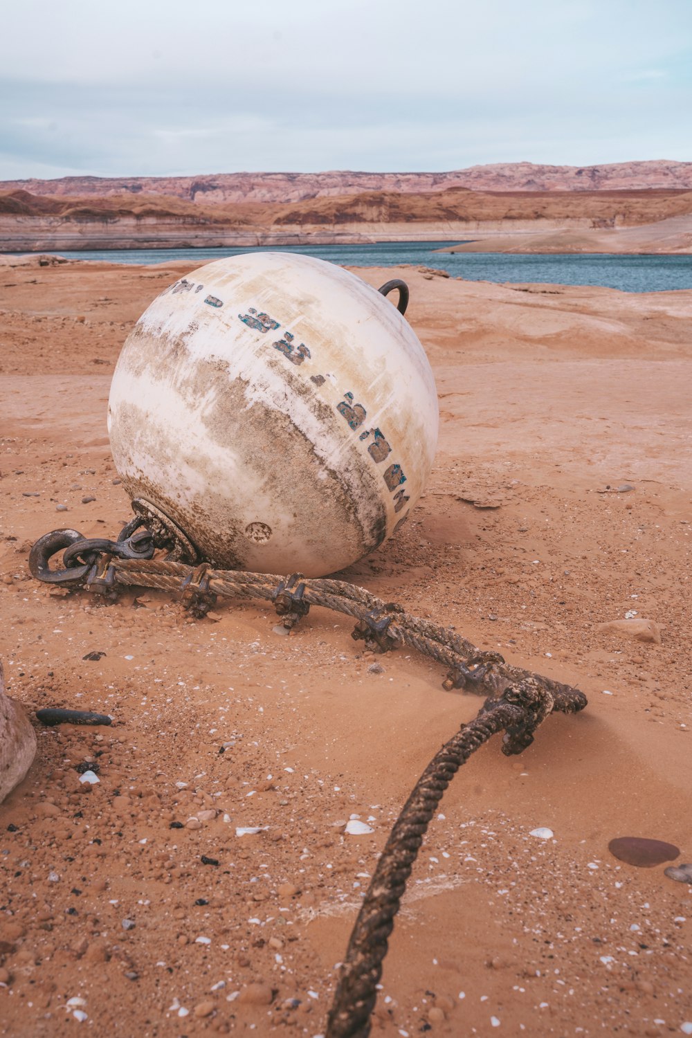 an old boat sitting on top of a sandy beach