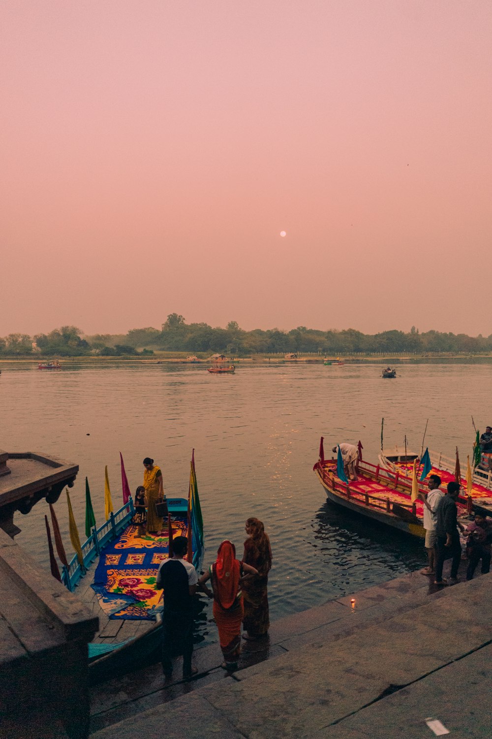 a group of people standing next to a body of water