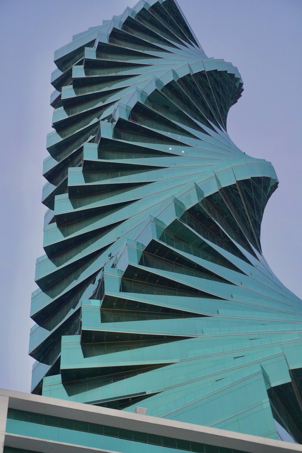 a tall building with a spiral design on it's side