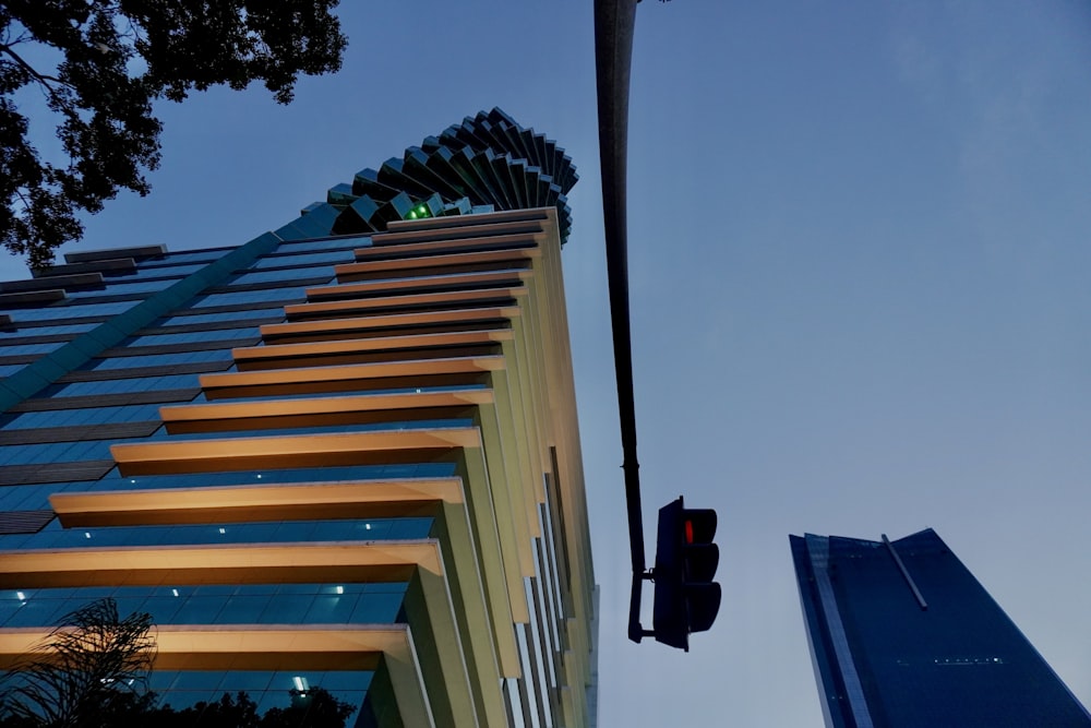 a traffic light hanging from the side of a tall building