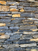 Stacked dimension stone ready for delivery, highlighting the variety of colors and finishes available.