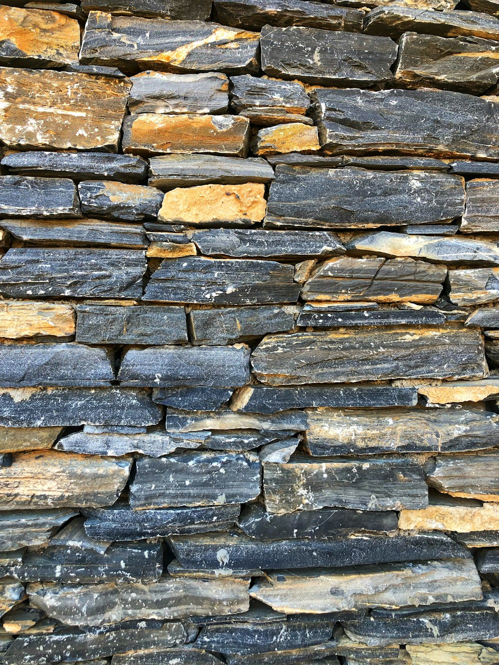 a close up of a stone wall made of rocks