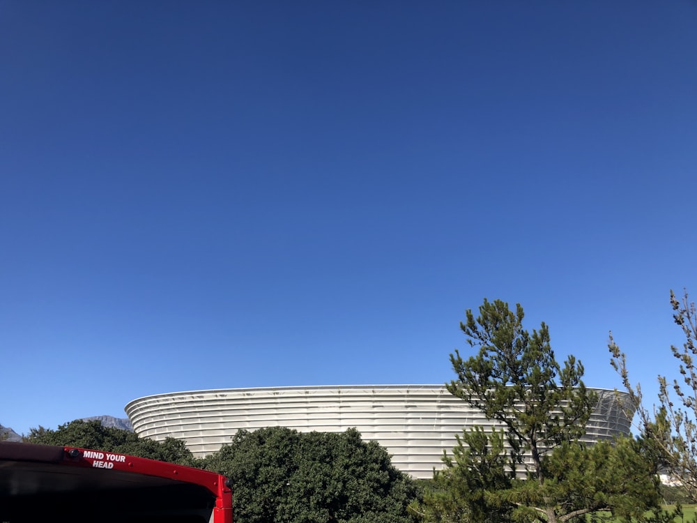 a red truck parked in front of a large building