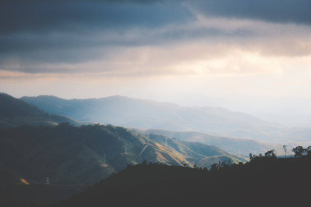 a view of a mountain range under a cloudy sky