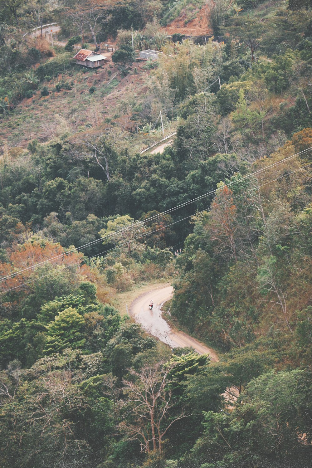 a person riding a motorcycle down a dirt road