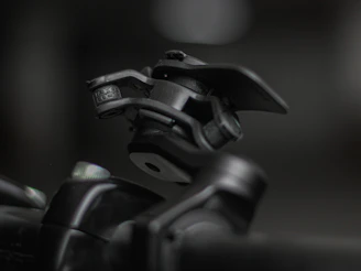 Close-up image of precision metal hinges arranged neatly on a dark industrial surface.