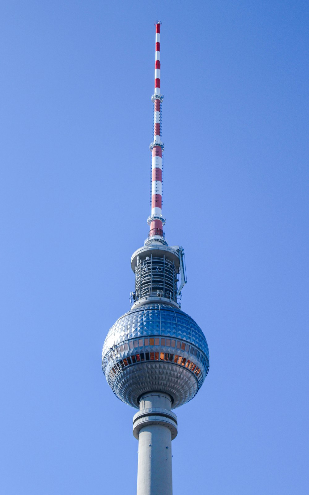a tall tower with a red and white striped top