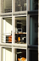 Modern office with security cameras and solar panels visible outside.